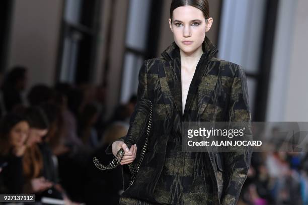 Model presents a creation for Akris during the 2018/2019 fall/winter collection fashion show on March 4, 2018 in Paris.