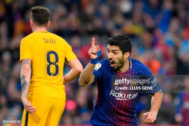 Barcelona's Uruguayan forward Luis Suarez celebrates after scoring during the Spanish league football match FC Barcelona against Club Atletico de...