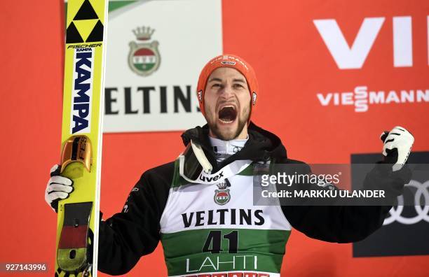 Markus Eisenbichler of Germany celebrates on the podium after the HS130 men's ski jumping event at the FIS World Cup in Lahti, Finland, on March 4,...