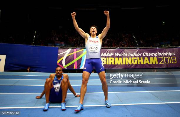 Gold Medallist, Andrew Pozzi of Great Britain celebrates winning the Men's 60 Metres Hurdles Final as Aries Merritt of United States looks dejected...
