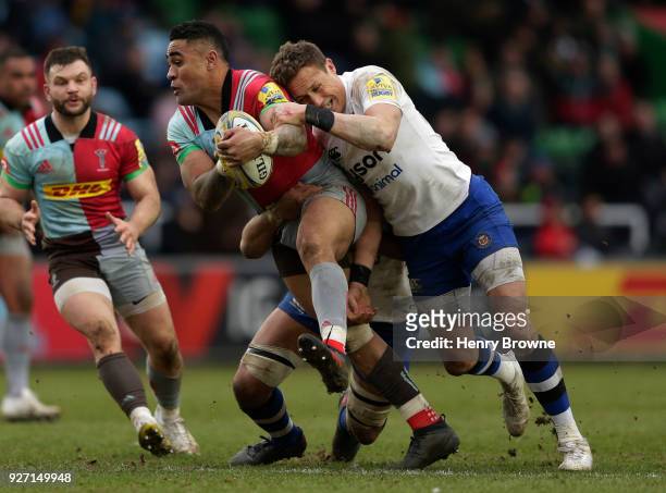 Francis Saili of Harlequins tackled by James Wilson and Taulupe Faletau of Bath Rugby during the Aviva Premiership match between Harlequins and Bath...