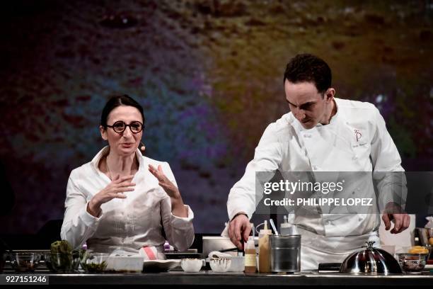 French Chef Anne-Sophie Pic and her executive chef Hugo Bourny take part in a cooking demonstration during the Omnivore culinary festival in Paris on...