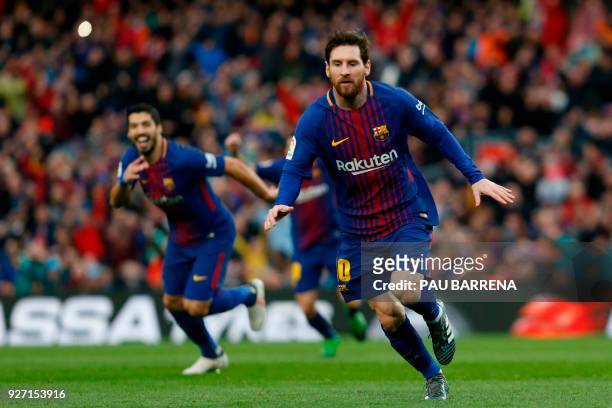 Barcelona's Argentinian forward Lionel Messi celebrates after scoring during the Spanish league football match FC Barcelona against Club Atletico de...
