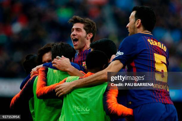 Barcelona's players celebrate after Argentinian forward Lionel Messi scored during the Spanish league football match FC Barcelona against Club...