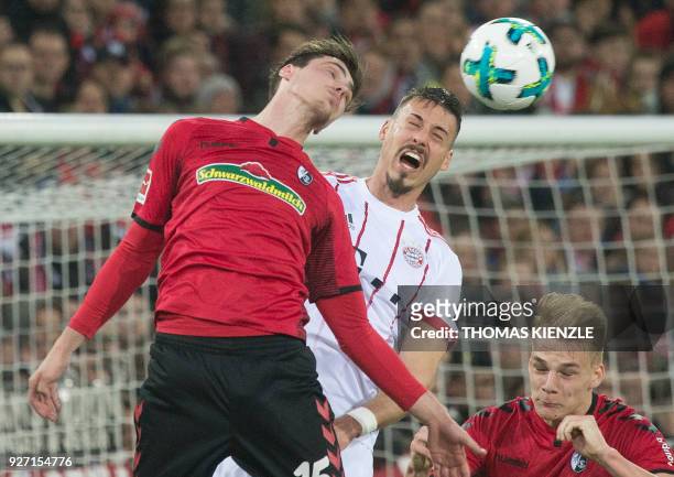 Freiburg's defender Pascal Stenzel and Munich's Sandro Wagner vie with the ball during the German first division Bundesliga football match SC...