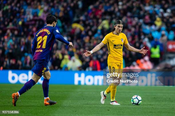 Filipe Luis from Brazil of Atletico de Madrid defended by 21 Andre Gomes from Portugal of FC Barcelona during La Liga match between FC Barcelona v...