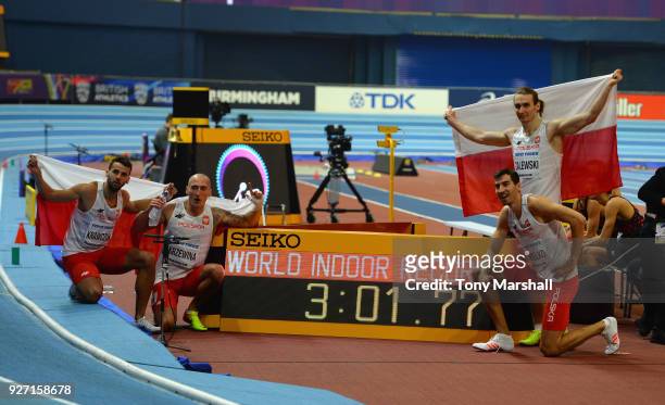 Lukasz Krawczuk, Jakub Krzewina, Rafal Omleko and Karol Zalewski of Poland celebrate winning the Men's 4 x 400m Relay Final and setting a new World...
