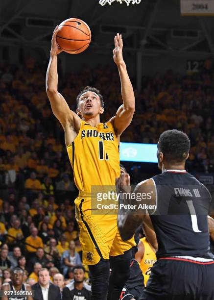 Landry Shamet of the Wichita State Shockers drives to the basket during the first half against Jacob Evans of the Cincinnati Bearcats on March 4,...