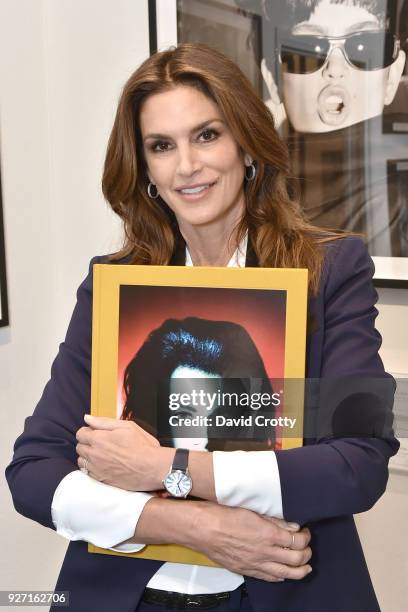 Supermodel Cindy Crawford holding Matthew Rolston's Hollywood Royale book at Rolston's Hollywood Royale exhibition preview at Fahey/Klein Gallery on...