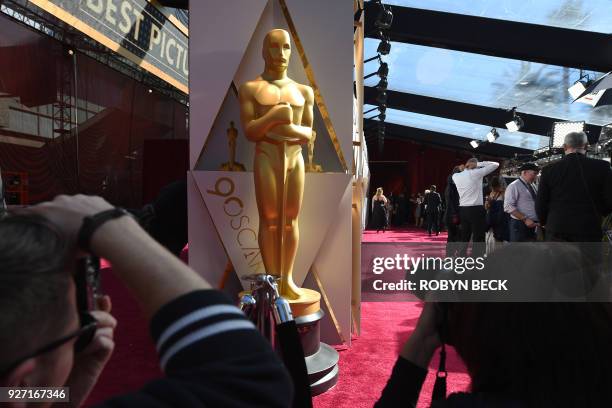 Photographers and TV crews get ready on the red carpet a few hours before the "Oscars", the 90th Annual Academy Awards on March 4 in Hollywood,...