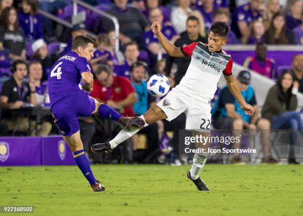 Orlando City midfielder Will Johnson challenges D.C. United midfielder Yamil Asad for possession during the MLS soccer match between the Orlando City...