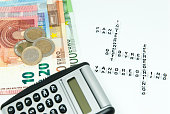 euro and calculator and words written in danish representing household monthly expenses concept photo