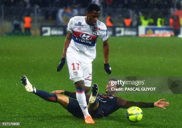 Lyon's French forward Myziane Maolida vies with Montpellier's Portuguese defender Pedro Mendes during the French L1 football match between...