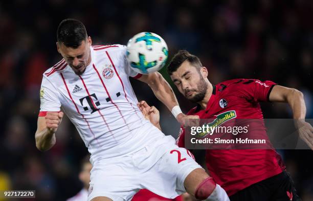 Sandro Wagner of Muenchen jumps for a header with Manuel Gulde of Freiburg during the Bundesliga match between Sport-Club Freiburg and FC Bayern...