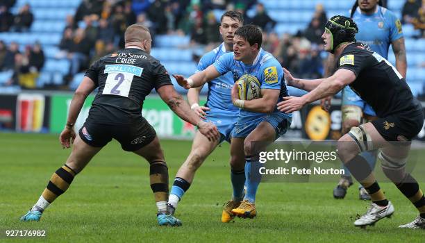 Piet van Zyl of London Irish attempts to move between James Gaskell and Tom Cruse of Wasps during the Aviva Premiership match between Wasps and...
