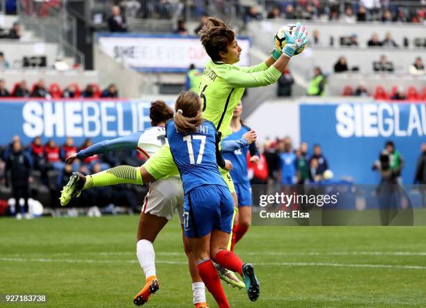 Sarah Bouhaddi of France makes the stop as teammate Marion Torrent defends during the SheBelieves Cup at Red Bull Arena on March 4, 2018 in Harrison,...