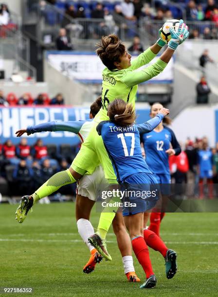 Sarah Bouhaddi of France makes the stop as teammate Marion Torrent defends during the SheBelieves Cup at Red Bull Arena on March 4, 2018 in Harrison,...