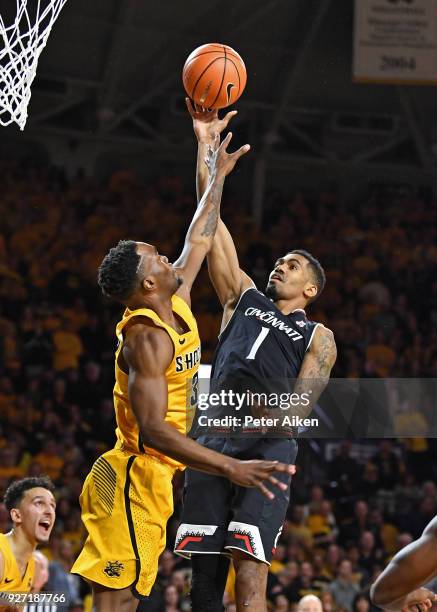 Jacob Evans of the Cincinnati Bearcats scores a basket over Markis McDuffie of the Wichita State Shockers during the second half on March 4, 2018 at...