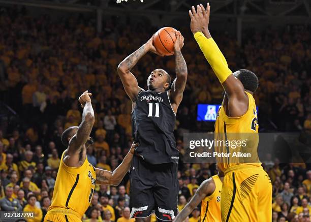 Gary Clark of the Cincinnati Bearcats puts up a shot against Rashard Kelly of the Wichita State Shockers during the second half on March 4, 2018 at...