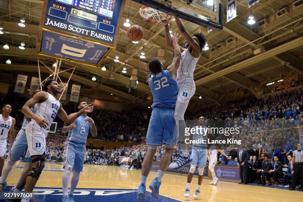 Marvin Bagley III of the Duke Blue Devils dunks the ball against Luke Maye of the North Carolina Tar Heels at Cameron Indoor Stadium on March 3, 2018...