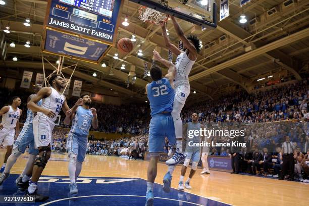 Marvin Bagley III of the Duke Blue Devils dunks the ball against Luke Maye of the North Carolina Tar Heels at Cameron Indoor Stadium on March 3, 2018...