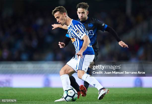 Sergio Canales of Real Sociedad being followed by Alvaro Medran of Deportivo Alaves during the La Liga match between Real Sociedad and Deportivo...