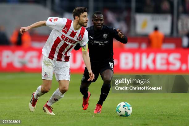 Chadrac Akolo of Stuttgart challenges Jonas Hector of Koeln during the Bundesliga match between 1. FC Koeln and VfB Stuttgart at RheinEnergieStadion...