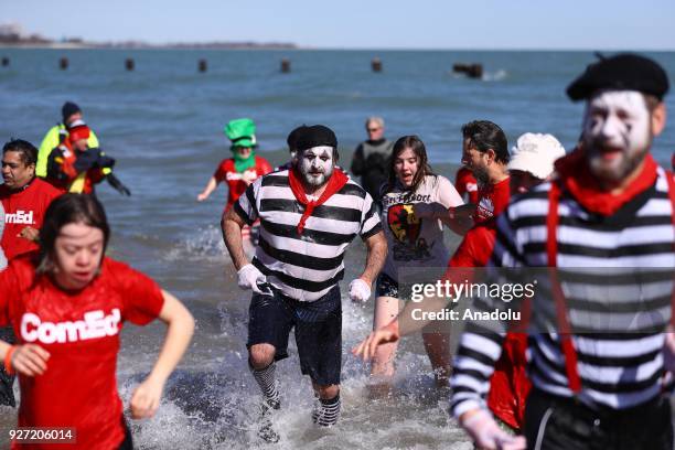 People take part in the 18th Annual Chicago Polar Plunge organized to support the athletes of Special Olympics at North Ave Beach of Michigan Lake in...