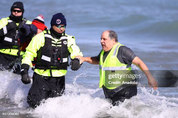 People take part in the 18th Annual Chicago Polar Plunge organized to support the athletes of Special Olympics at North Ave Beach of Michigan Lake in...