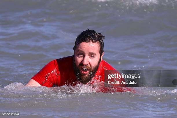 Man takes part in the 18th Annual Chicago Polar Plunge organized to support the athletes of Special Olympics at North Ave Beach of Michigan Lake in...