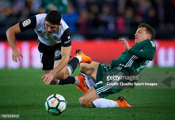Goncalo Guedes of Valencia competes for the ball with Francis of Real Betis during the La Liga match between Valencia and Real Betis at Mestalla...