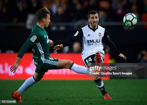 Jose Luis Gaya of Valencia competes for the ball with Francis of Real Betis during the La Liga match between Valencia and Real Betis at Mestalla...