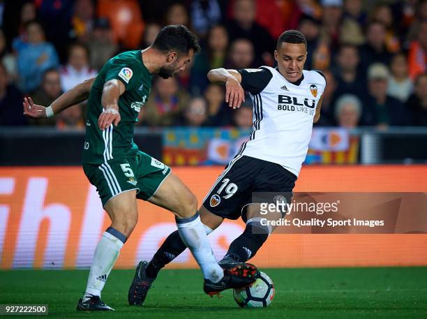 Rodrigo Moreno of Valencia competes for the ball with Jordi Amat of Real Betis during the La Liga match between Valencia and Real Betis at Mestalla...