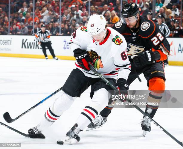 Carl Dahlstrom of the Chicago Blackhawks and Chris Kelly of the Anaheim Ducks battle for the puck during the first period of the game at Honda Center...