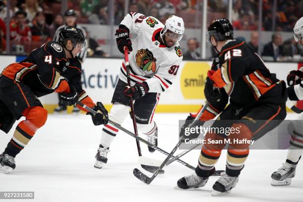 Anthony Duclair of the Chicago Blackhawks shoots the puck as Cam Fowler and Josh Manson of the Anaheim Ducks defend during the second period of a...