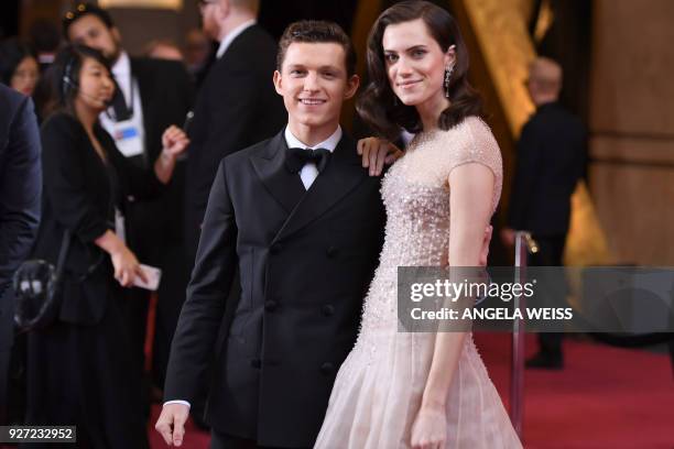 Actress Allison Williams and British actor Tom Holland pose as they arrive for the 90th Annual Academy Awards on March 4 in Hollywood, California. /...