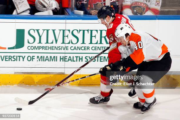 Maxim Mamin of the Florida Panthers skates with the puck against Jordan Weal of the Philadelphia Flyers at the BB&T Center on March 4, 2018 in...