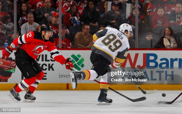 Alex Tuch of the Vegas Golden Knights follows through on a shot in the first period against Ben Lovejoy of the New Jersey Devils on March 4, 2018 at...