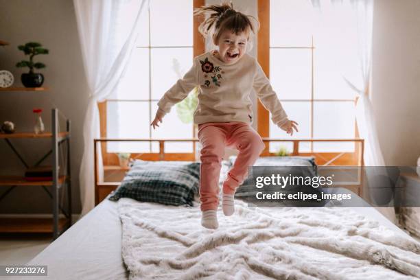 happy child in bed - cartwheel stock pictures, royalty-free photos & images