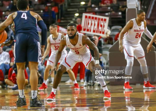 Houston Cougars guard Corey Davis Jr. Guards Connecticut Huskies guard Jalen Adams during the men's basketball game between the UConn Huskies and...