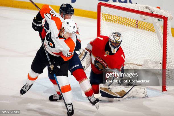 Goaltender Roberto Luongo of the Florida Panthers defends the net with the help of teammate Mark Pysyk against Oskar Lindblom of the Philadelphia...