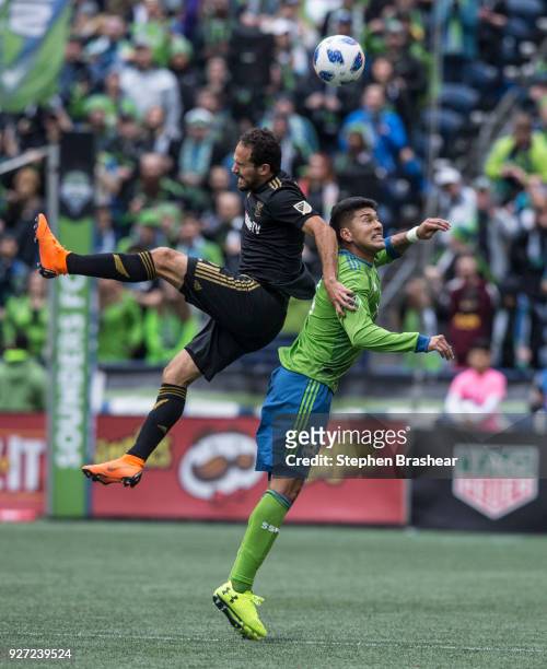 Marco Urena of Los Angeles FC and Tony Alfaro of the Seattle Sounders go up for a header during the first half of a match at CenturyLink Field on...