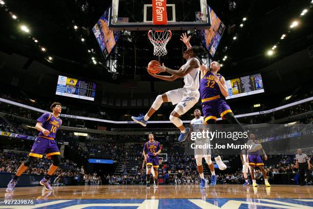 Kyvon Davenport of the Memphis Tigers shoots a reverse layup against Dimitrije Spasojevic of the East Carolina Pirates on March 4, 2018 at FedExForum...