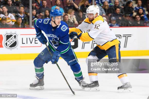 Nikolay Goldobin of the Vancouver Canucks is checked by Mike Fisher of the Nashville Predators during their NHL game at Rogers Arena on March 2, 2018...