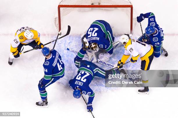 Jacob Markstrom makes a save as Alexander Edler Erik Gudbranson and Bo Horvat of the Vancouver Canucks defend against Calle Jarnkrok and Miikka...