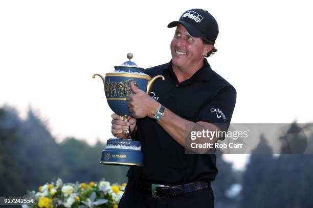 Phil Mickelson gives a thumb up to fans as he holds the Gene Sarazen Cup after winning the World Golf Championships-Mexico Championship on a playoff...