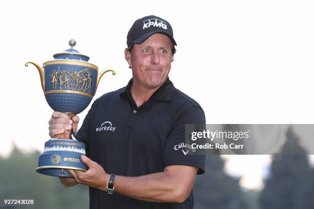 Phil Mickelson poses with the Gene Sarazen Cup after winning the World Golf Championships-Mexico Championship on a playoff hole at Club De Golf...