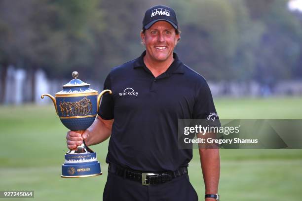 Phil Mickelson poses with the Gene Sarazen Cup after winning the World Golf Championships-Mexico Championship on a playoff hole at Club De Golf...