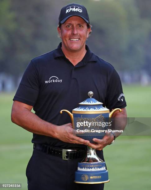 Phil Mickelson poses with the Gene Sarazen Cup after winning the World Golf Championships-Mexico Championship on a playoff hole at Club De Golf...