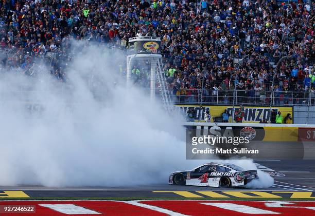Kevin Harvick, driver of the Jimmy John's Ford, celebrates with a burnout after winning the Monster Energy NASCAR Cup Series Pennzoil 400 presented...